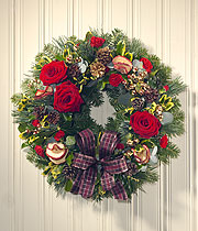 Christmas wreath, red roses and a purple ribbon