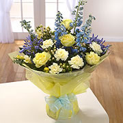 A bouquet of white and yellow roses adorned with Bluebells