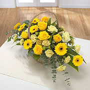 A basket, bouquet, of white and yellow roses with yellow daisies
