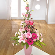 A vase, bouquet, of pink roses, purple daisies and pink, open, daffodils