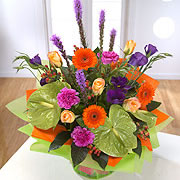 A bouquet orange and purple daisies, orange roses and purple Blazing-Stars