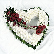 A large, heart shaped, posy, adorned with red roses