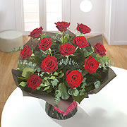 A bouquet of a dozen long stemmed red roses