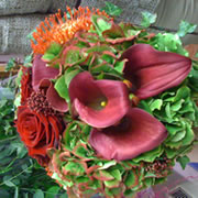 A bouquet of red roses and red Flamingo flowers